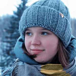 Julia Sadkova hymyilee katsoen sivulle talvisissa tunnelmissa.